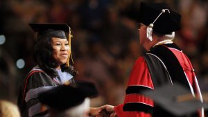 Chancellor Randy Woodson congratulates a graduate as she receives her graduate degree.